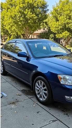 Freshly detailed blue sedan exterior with glossy paint finish
